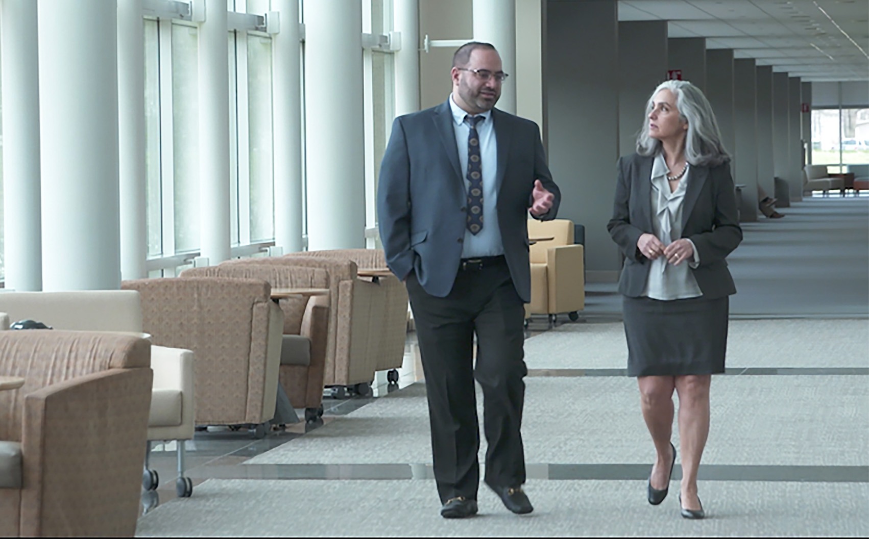 Two colleagues walk and talk