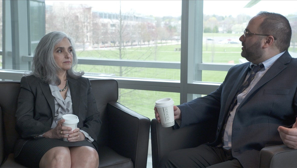 Two colleagues sit and talk