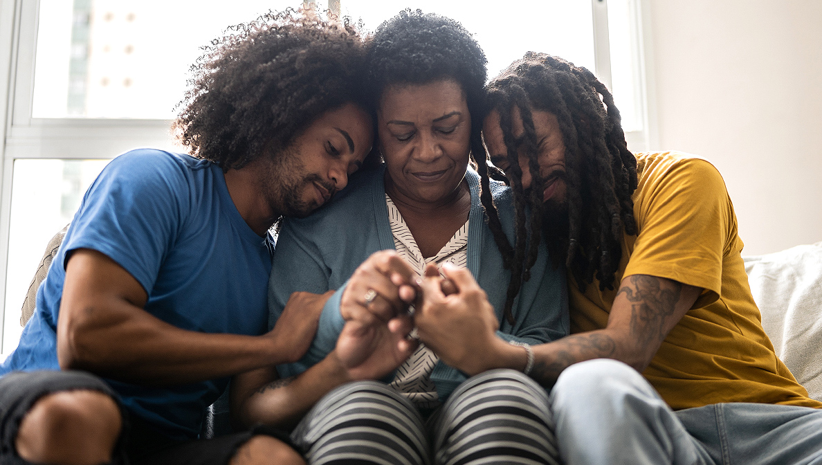 Family embracing on couch