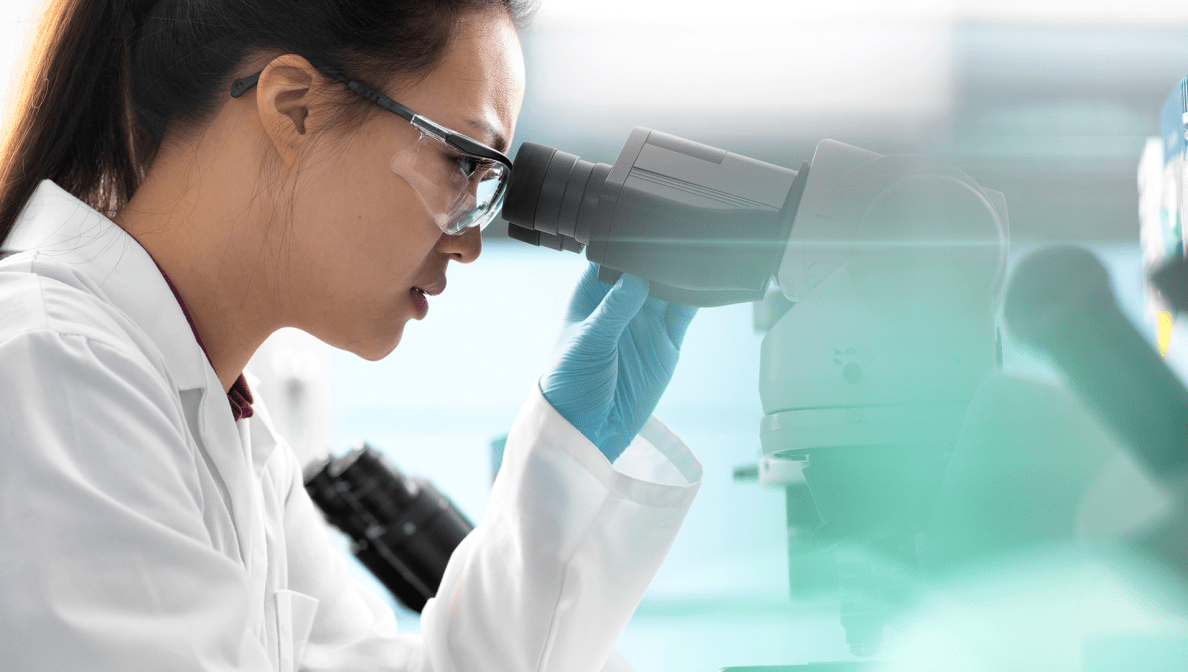 Scientist looks into microscope