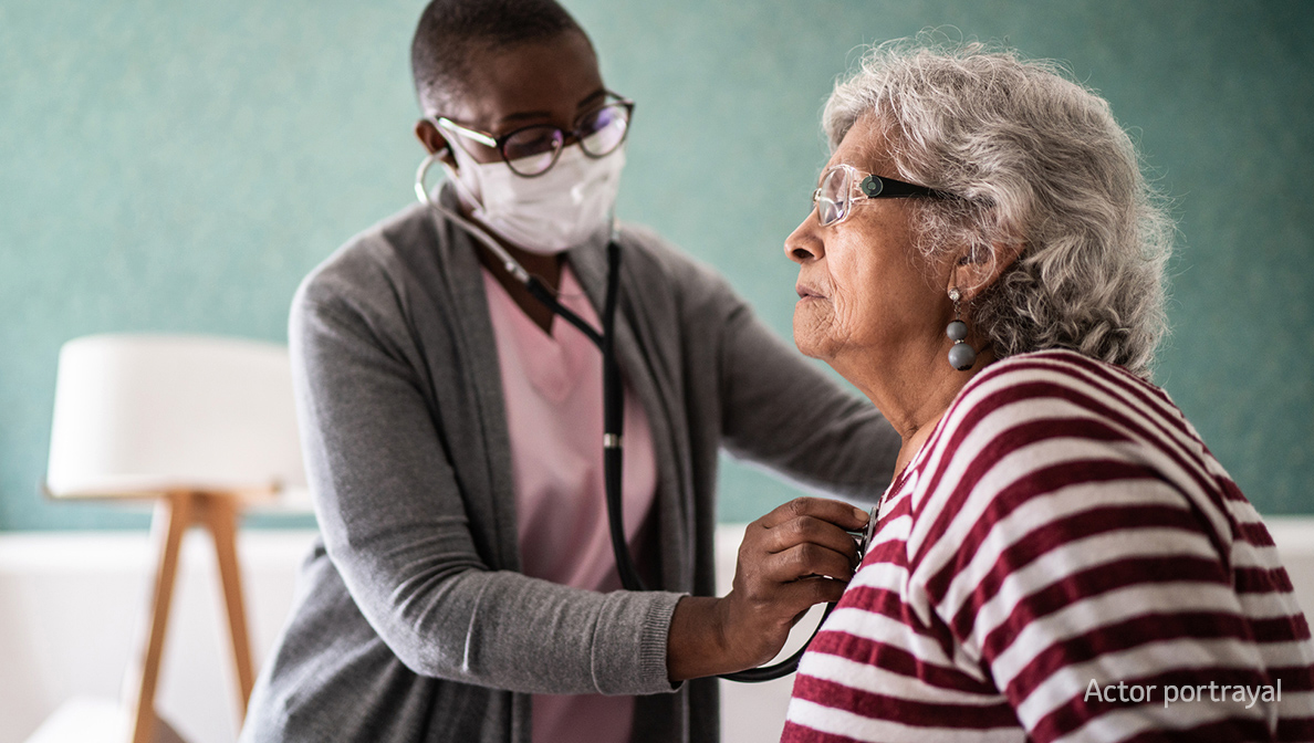 doctor using stethoscope on patient
