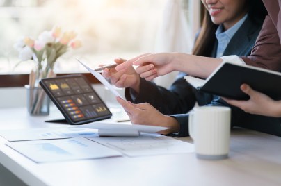 hands of two women working on computer