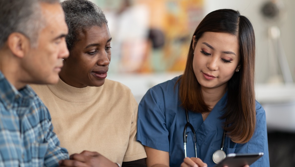 Senior couple reviewing medical information with a health care provider