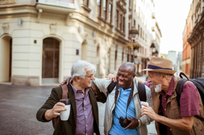 Three people outdoors smiling.