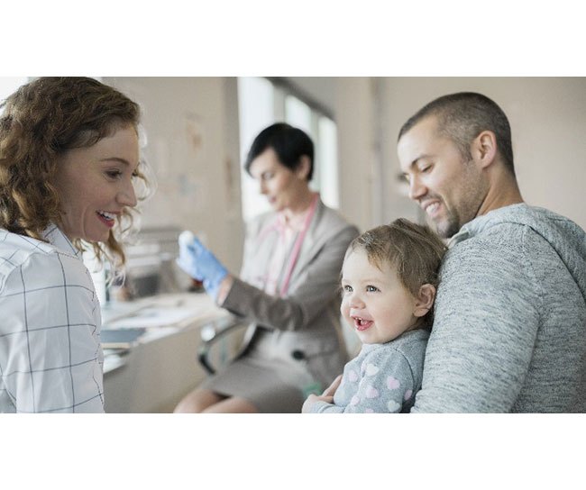 Father with child getting vaccinated