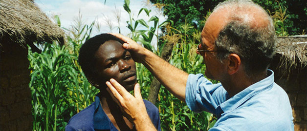 a doctor checking a man for river blindness