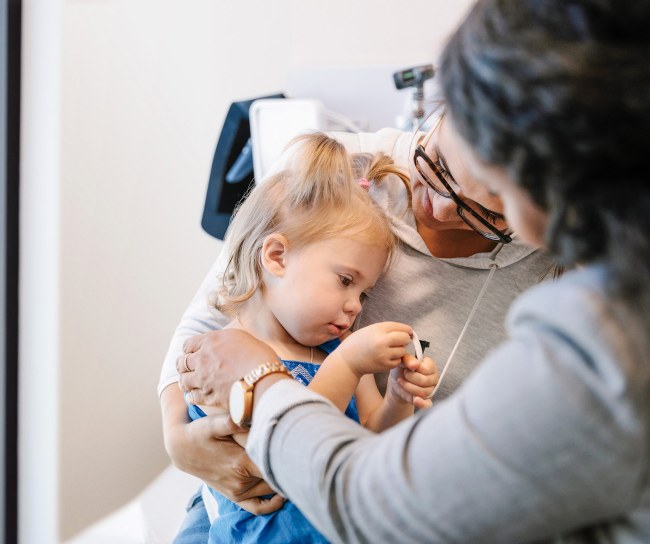 young blonde girl with mom in doctors office