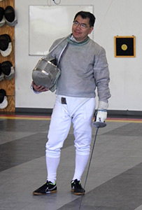 Man in fencing uniform and foil