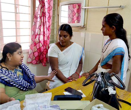 Clinician consulting two women in India