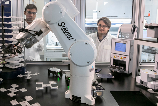 Technicians using the staubli machine