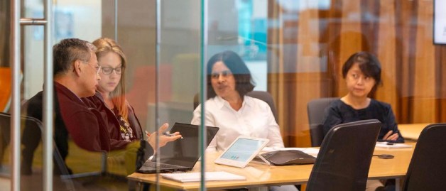 Team working together in a glass room