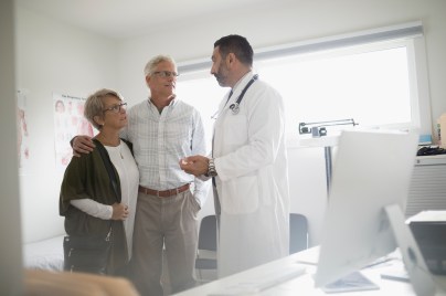 Doctor consulting elderly couple