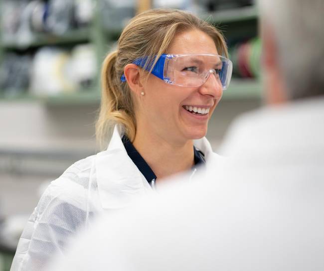 Scientist smiling wearing goggles