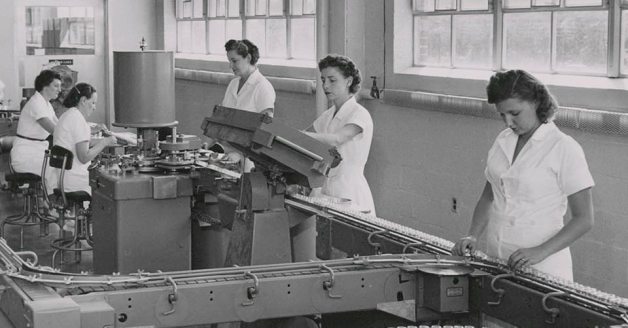 Female employees working with machinery