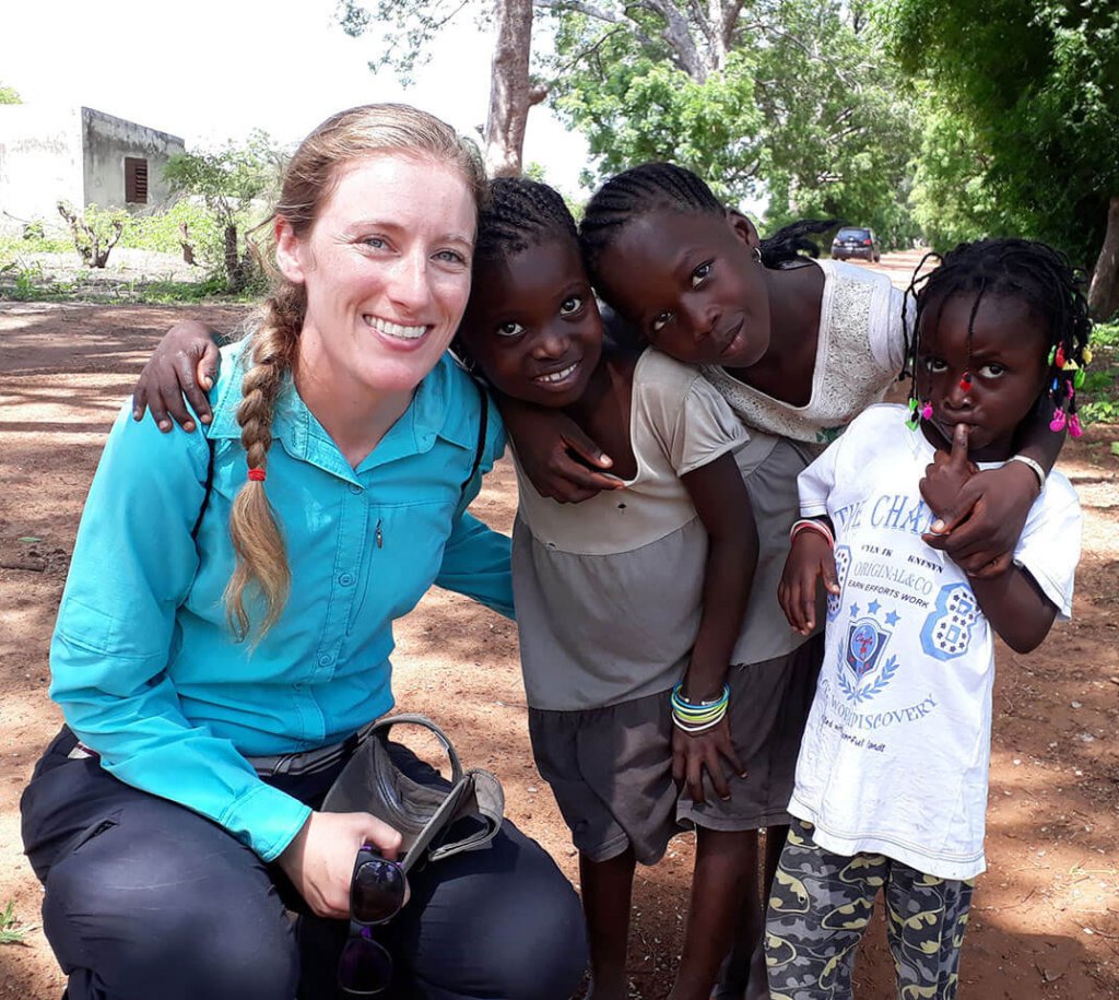 Merck volunteer smiling with kids in Africa