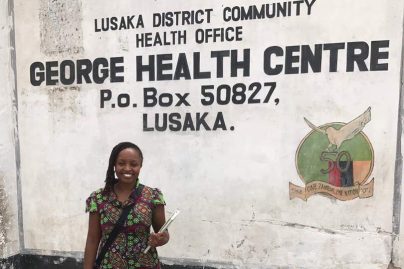 Dr. Bern standing in front of health center in Zambia