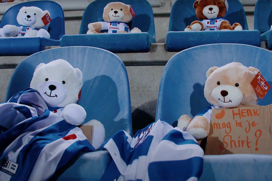 Teddy bears sitting in a stadium at a soccer match