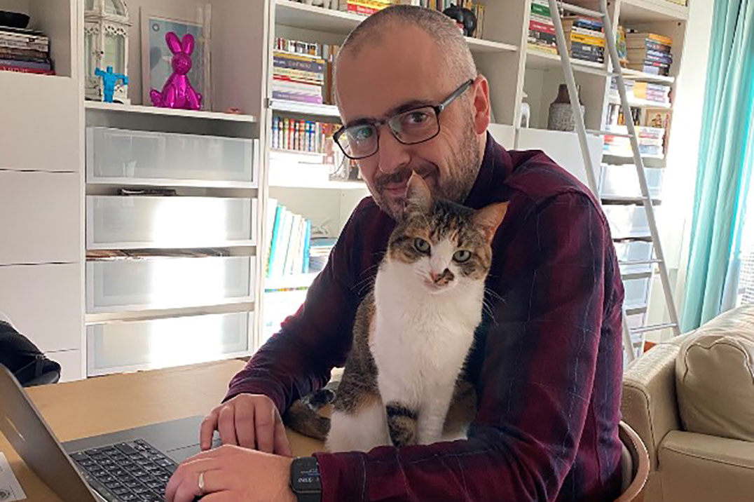 Man working with his cat