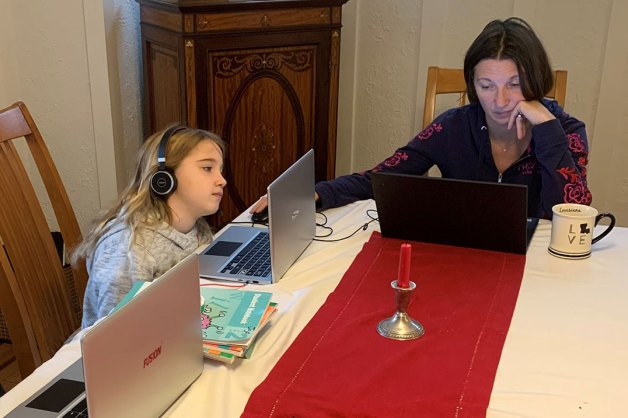 Kristina Rey working at home with her children