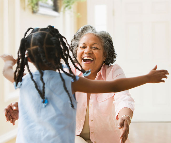 Grandmother giving her granddaughter a hug