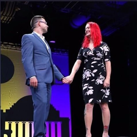 Allison Whitaker holding hands on stage