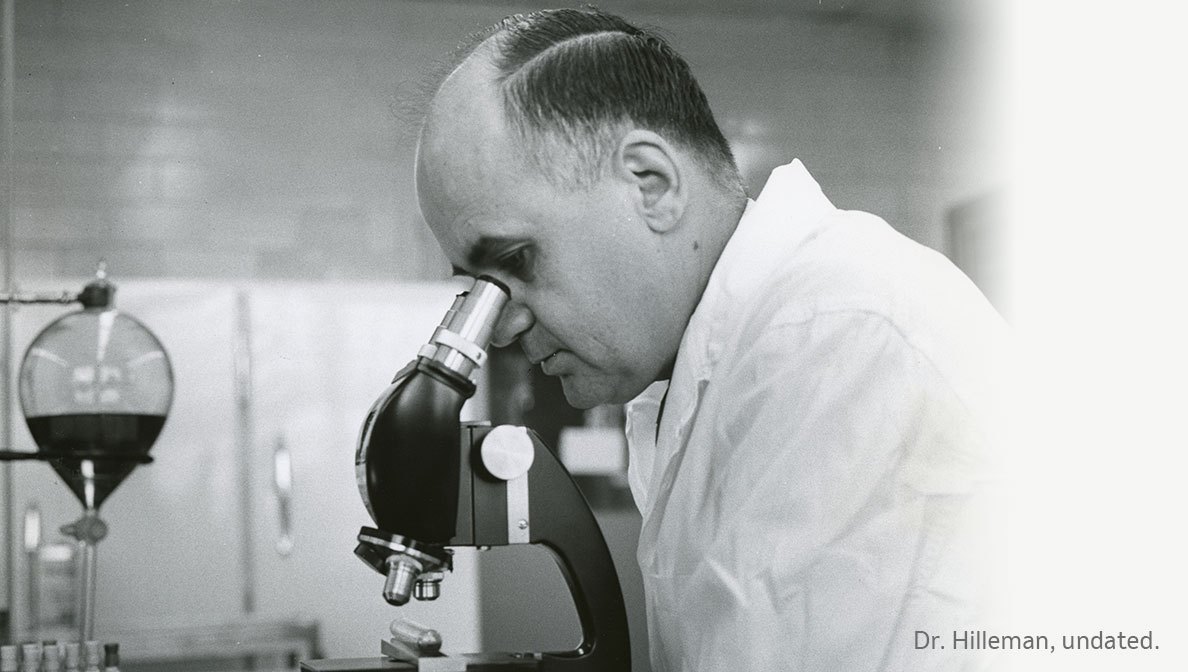 Maurice Hilleman looking into a microscope