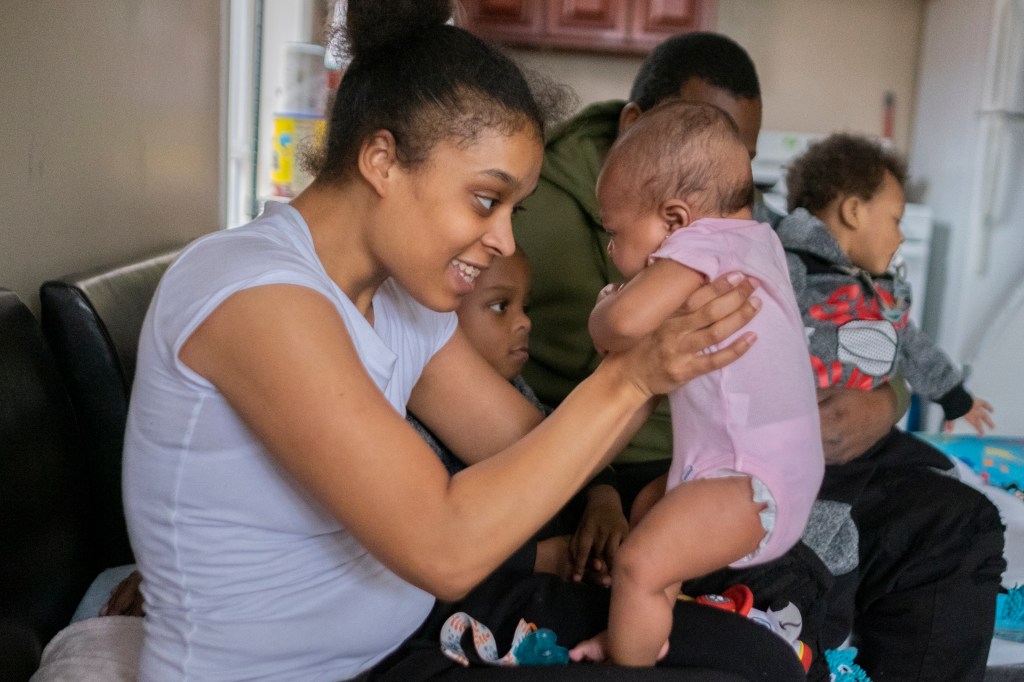 woman holding baby smiling