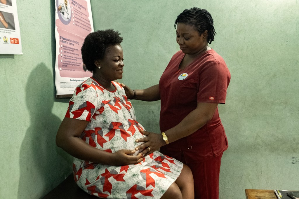 pregnant woman being examined by a nurse