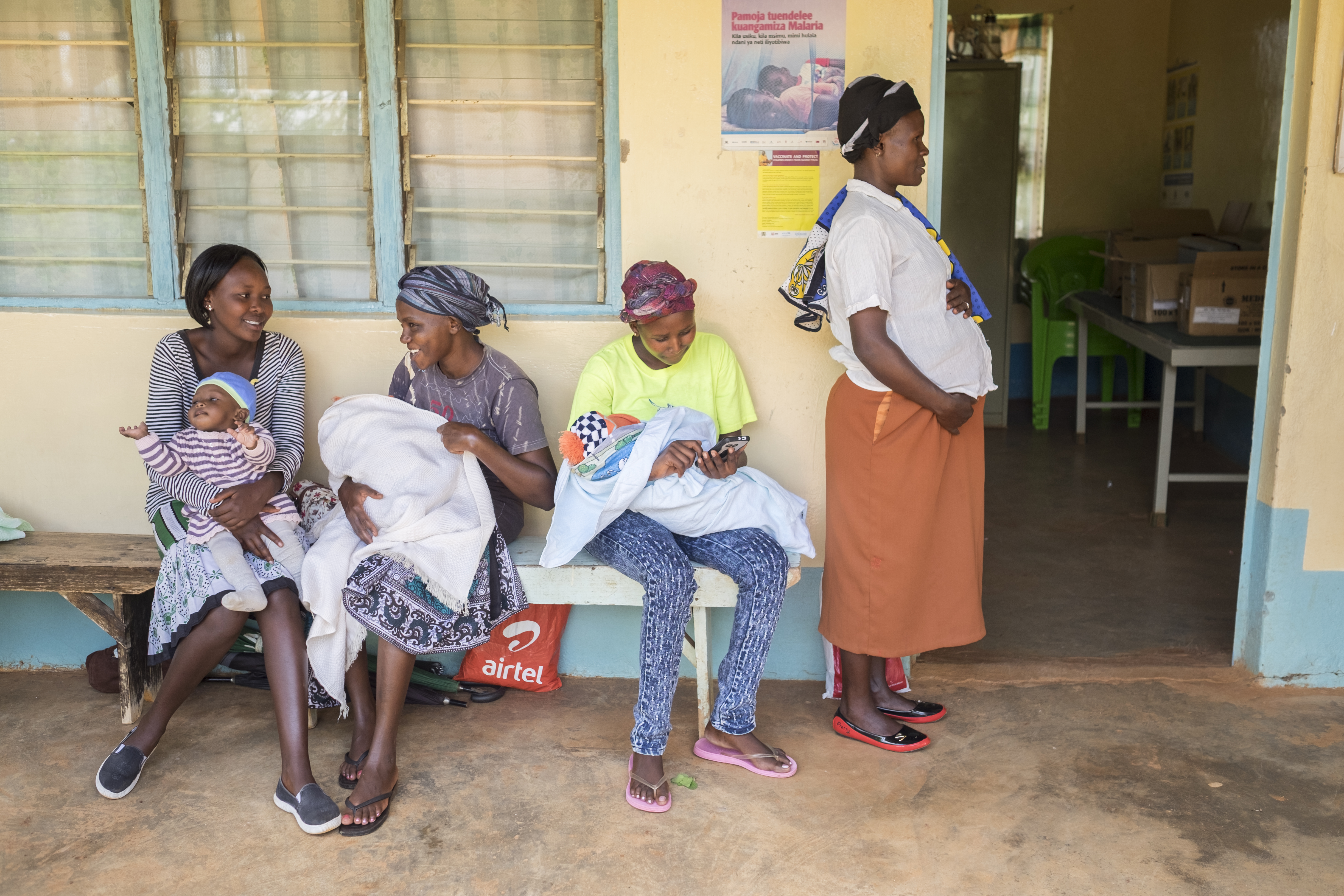3 women holding babies and one pregnant woman in Kenya