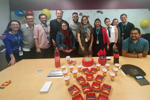 Coworkers come together in conference room with treats