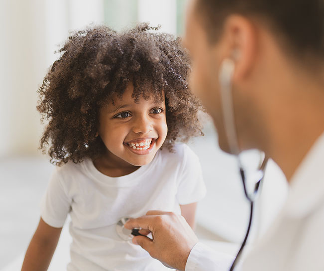 doctor checking a child's lungs