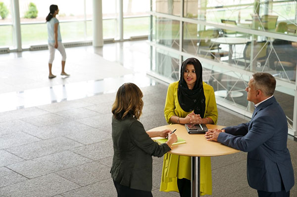 colleagues standing at a table