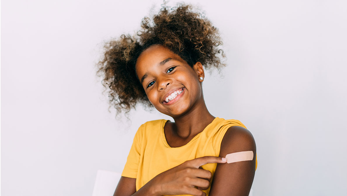 a girl with a band aid on her arm