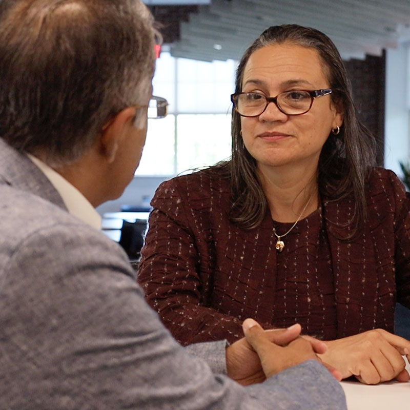 Janethe Pena talking with colleague