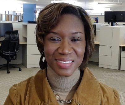 Esther Smith-Howell headshot in cubicle