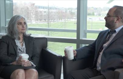 Two colleagues sit and talk