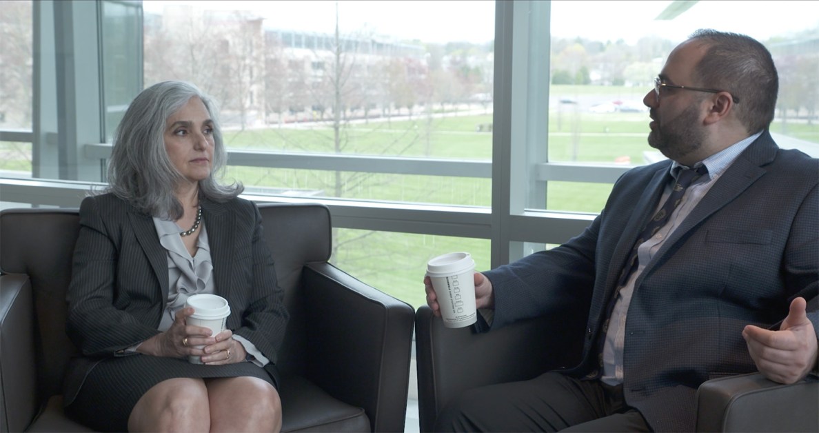 Two colleagues sit and talk