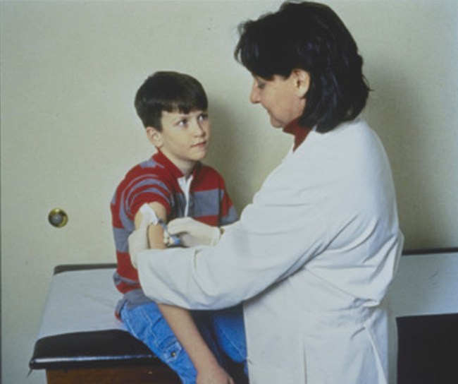 Doctor giving vaccine to child