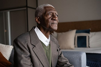 Senior gentleman looks out of window