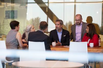 Group of employees in discussion at conference table