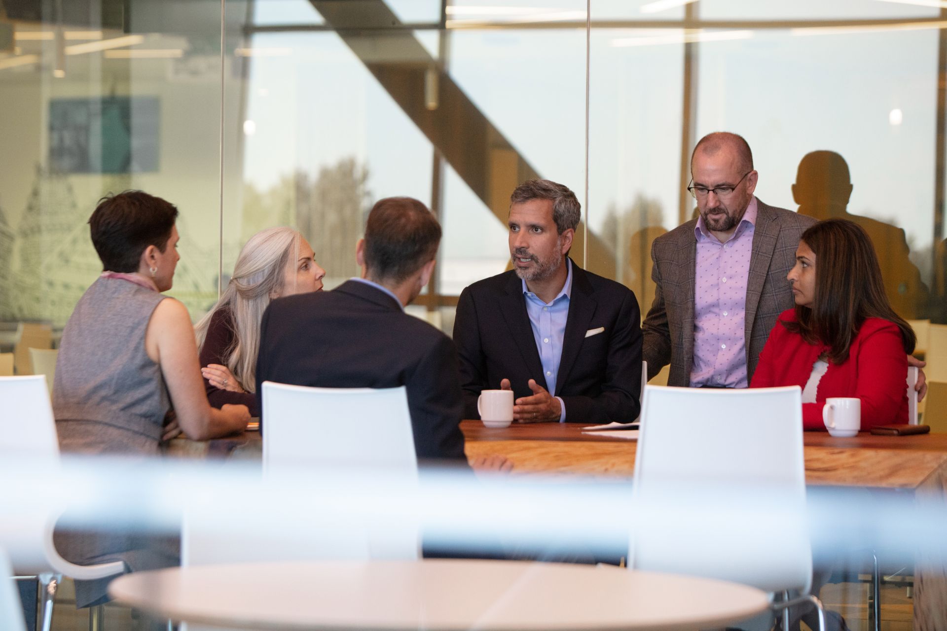 Group of employees in discussion at conference table