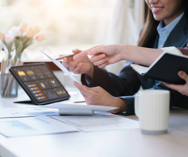 hands of two women working on computer