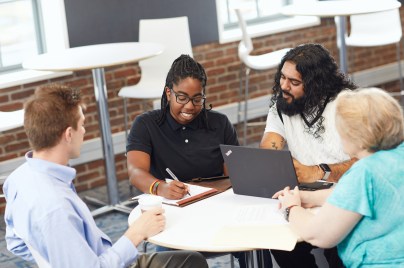 Inspiring diverse colleagues collaborate over innovative strategy through diversity and inclusion