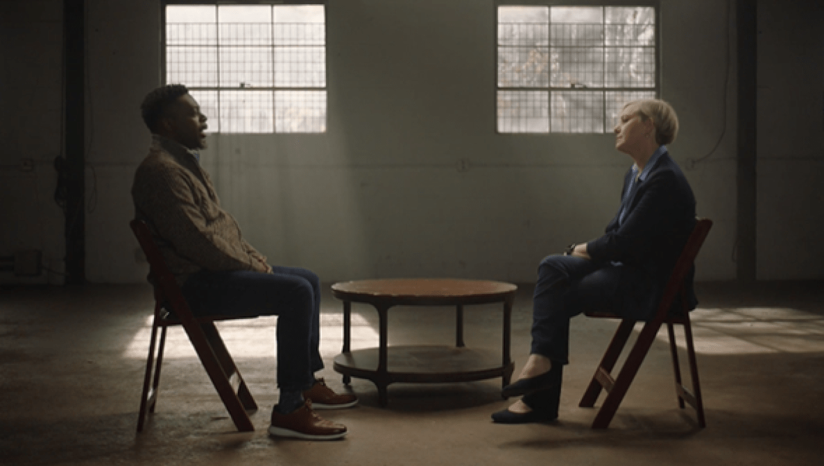 Two people sit down face to face for a chat