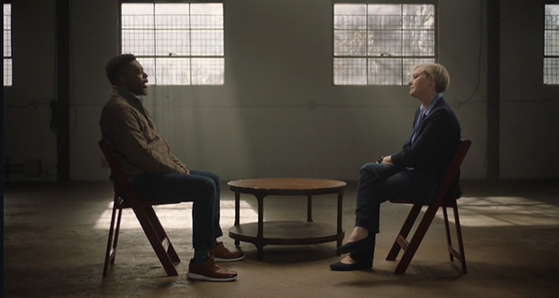 Two people sit down face to face for a chat