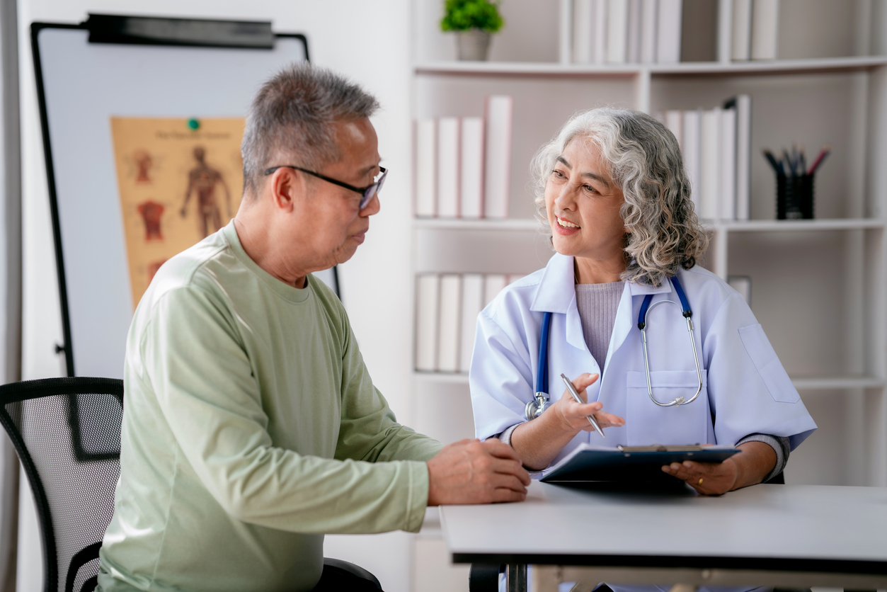 Female doctor listening to symptoms of senior patient