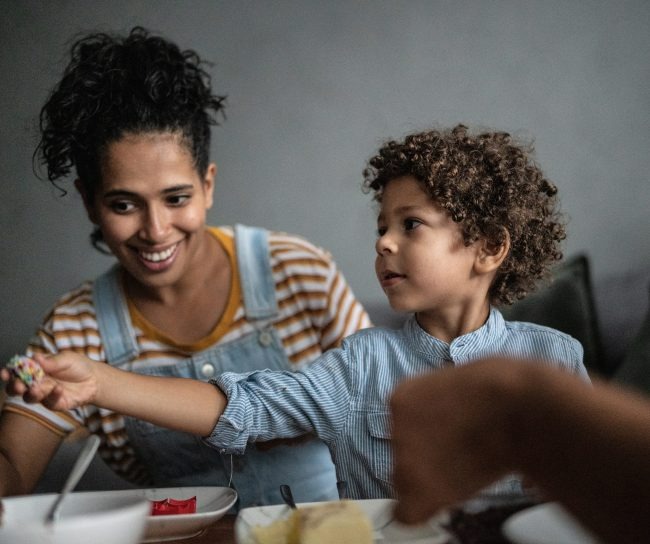 mother and son smiling and eating