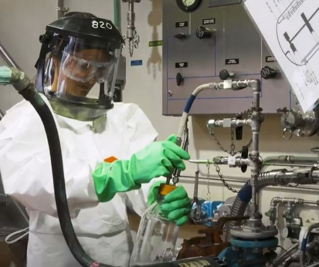 scientist working in lab wearing PPE