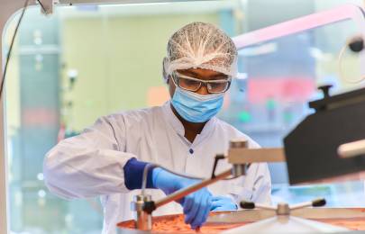 Scientist wearing full protective gear working