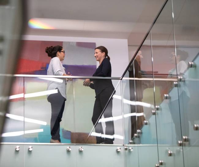 two women talking in an office building